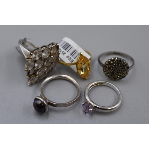54 - Five 925. Silver Rings To Include Gold Tone Yellow Stoned Ring, Marcasite Stoned Ring (Some Missing ... 