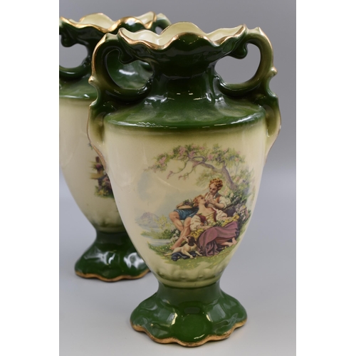 216 - A pair of Staffordshire vases in green and cream with gold highlights measuring 14