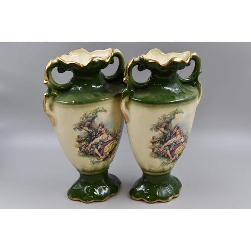 216 - A pair of Staffordshire vases in green and cream with gold highlights measuring 14