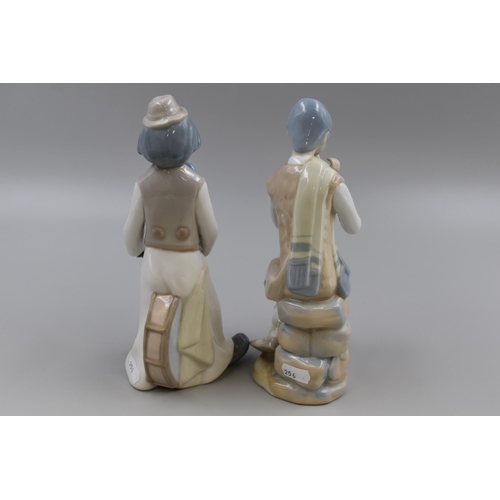 251 - Pair of Casades porcelain Statues to include a Flute Player and a Circus Clown a/f approx 9.5