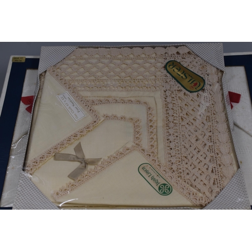 646 - Selection of six lace,linen and cotton table cloths and mats all boxed and new