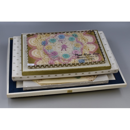 646 - Selection of six lace,linen and cotton table cloths and mats all boxed and new