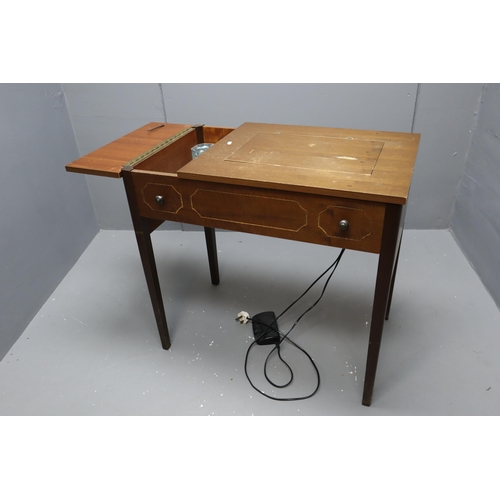 605 - A Retro Foldaway Singer Sewing Machine Table, Powers on When Tested. Some Cosmetic Damage to Wood Pa... 