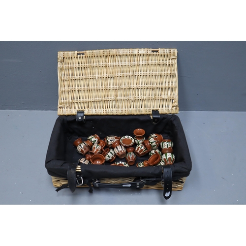 303 - Lined Wicker Basket to include a Selection of Miniature Stoneware (17” x 10” x 6”)