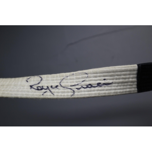 635 - A Two Piece Black Cotton Martial Arts Outifit, With White Belt. Belt Signed By Royce Gracie