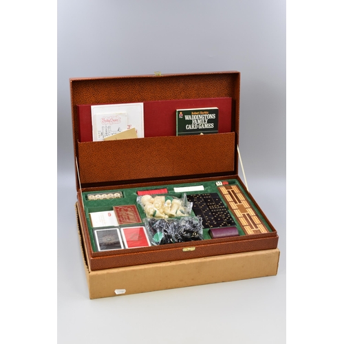 652 - A Cased Games Set. Includes Playing Cards, Chess, Checkers, Bridge and More