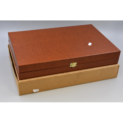 652 - A Cased Games Set. Includes Playing Cards, Chess, Checkers, Bridge and More