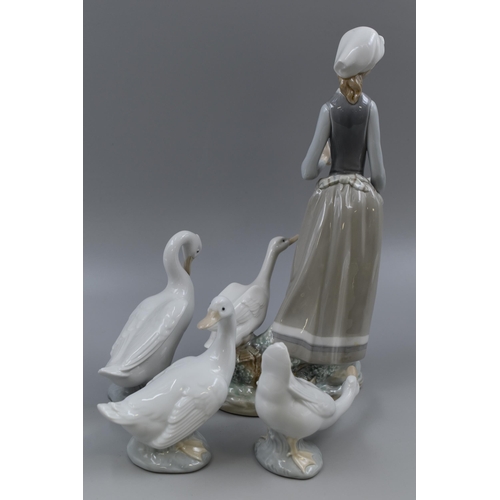 246 - A Lladro Woman With Geese Porcelain Figure, With Three Nao Geese Figures. Lladro is Approx 12.5