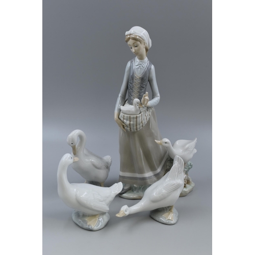 246 - A Lladro Woman With Geese Porcelain Figure, With Three Nao Geese Figures. Lladro is Approx 12.5