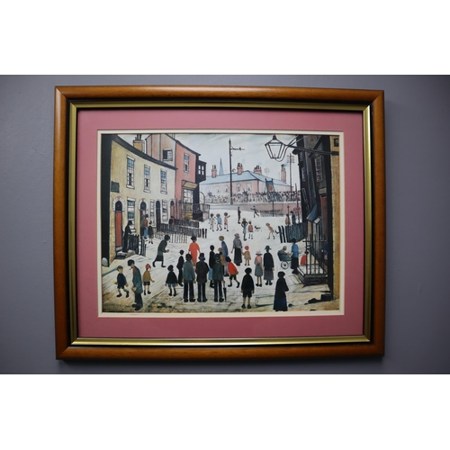 692 - A Framed and Glazed L.S. Lowry Print, ' A Procession'. Approx 18