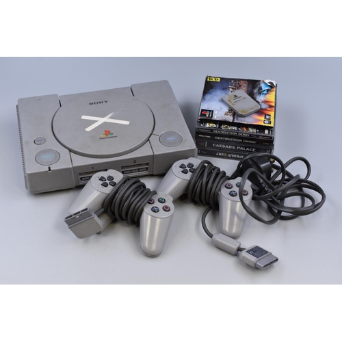 551 - A Sony Playstation With Two Controllers, Memory Card and a Selection of Games