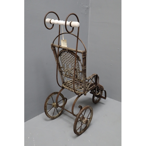 275 - An Antique Wicker and Cast Metal Three Wheel Toy Pram, Approx 28” Tall