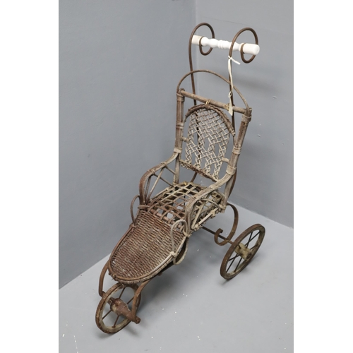 275 - An Antique Wicker and Cast Metal Three Wheel Toy Pram, Approx 28” Tall