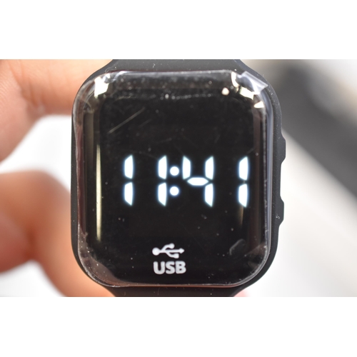 371 - LED pedometer watch in black with charging lead, boxed and in working condition