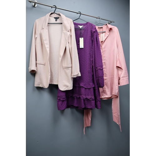 597 - Large Selection of Ladies Clothing in Various Sizes (Approx. 16 items). With Coat Hangers