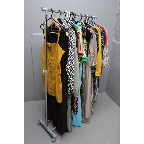 599 - Large Selection of Ladies Clothing in Various Sizes. Clothing Rail Included