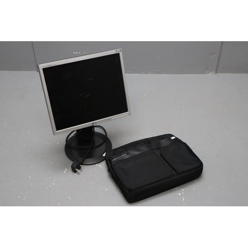 497 - Two items includes LG Monitor on Stand (Powers on) and a Targus Laptop Bag with Strap (Looks Unused)