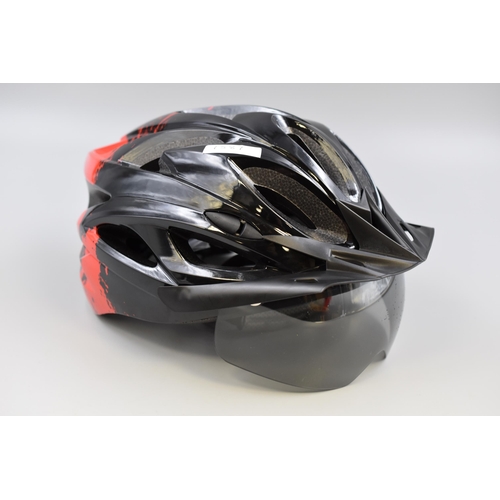 711 - Brand new Cycling helmet in red and black with visor and rechargeable rear light (includes charging ... 