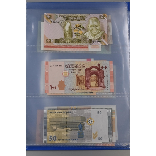 194 - Folder Containing a Large Selection of Uncirculated Worldwide Banknotes. Includes Zambia, Syria, Ban... 