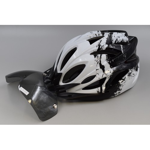 765 - Brand new Cycling helmet in black and white with visor and rechargeable rear light (includes chargin... 