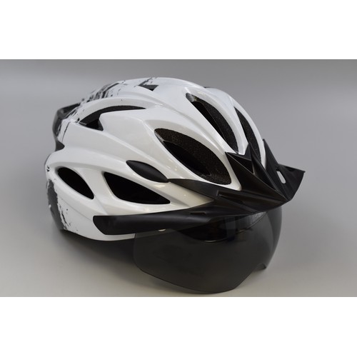 765 - Brand new Cycling helmet in black and white with visor and rechargeable rear light (includes chargin... 