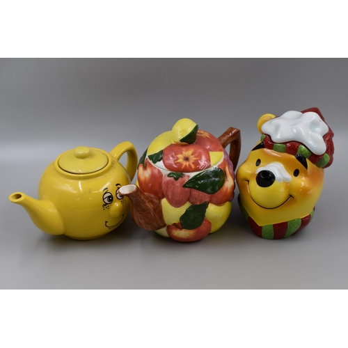 330 - Three Collectable Ceramic Teapots in the form of Winnie The Pooh, Smiley Yellow and a Pile of Fruit