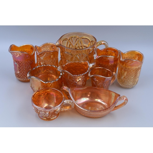 Eight Carnival Glass Jugs with a Tea Cup and two Handled Bowl