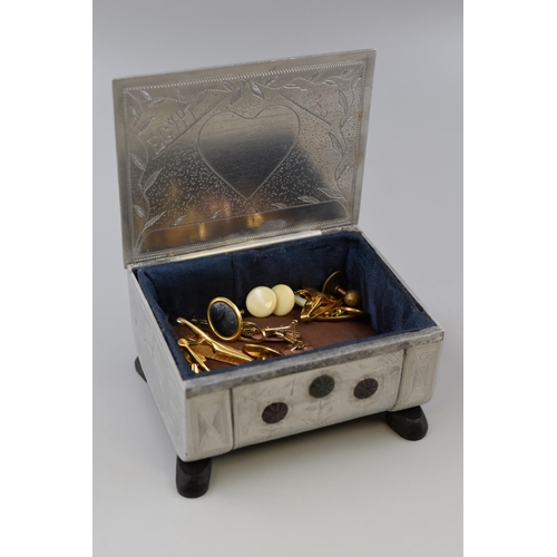 71 - A Metal Egyptian Etched Metal Jewellery Box With a Selection of Tie Clips, Cufflinks and Collar Stud... 