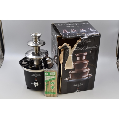 375 - Gourmet Gadgetry mini chocolate fountain, powers on when tested