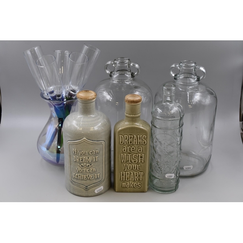 704 - Two Demijohns, Set of Long Stemmed Harlequin Champagne Flutes, two Glazed Stoneware Motto Bottles an... 