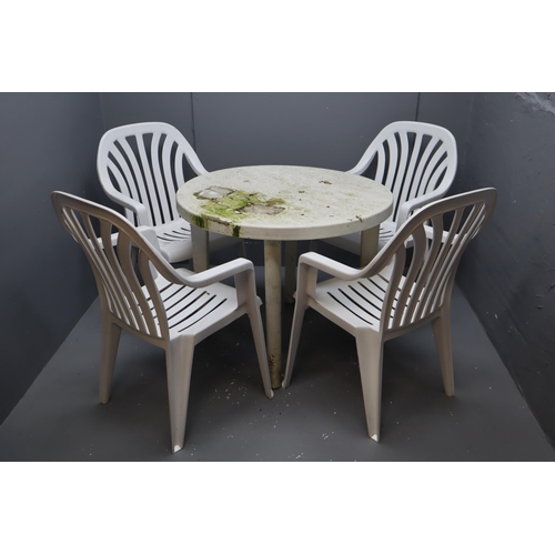 591 - White Plastic Circular Garden Table with Four Matching Chairs (table legs do remove for transportati... 