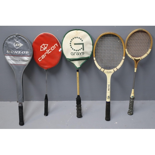 593 - 5x vintage rackets. £x squash rackets. 1x tennis and 1x badminton.