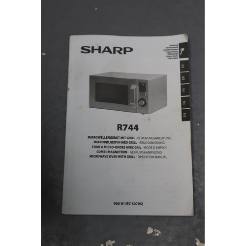 511 - Sharp R744 Microwave Oven powers on when tested complete with Instruction manual