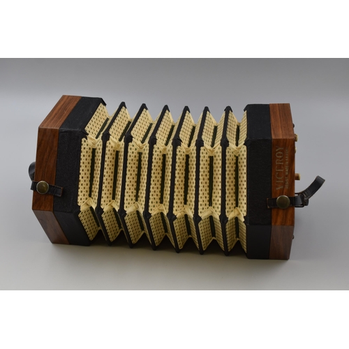 374 - A German-made concertina with five division paper bellows, fret cut mahogany ends, bears label 'broa... 