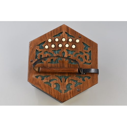 374 - A German-made concertina with five division paper bellows, fret cut mahogany ends, bears label 'broa... 