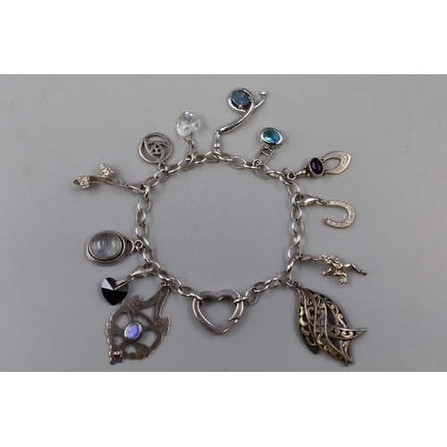 82 - A Sterling Silver Charm Bracelet With a Selection of Twelve Sterling Silver Charms