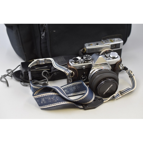 569 - Camera equipment to include Olympud OM2 SLR with 50mm lens in leather case, Olympus MJUII camera in ... 