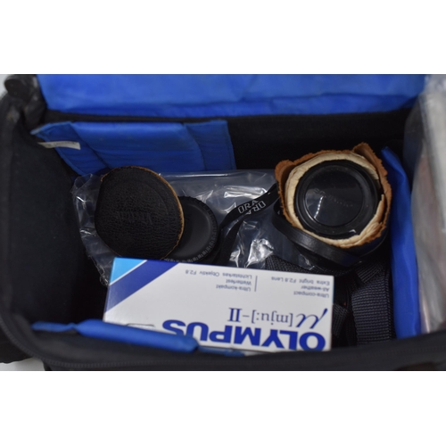 569 - Camera equipment to include Olympud OM2 SLR with 50mm lens in leather case, Olympus MJUII camera in ... 