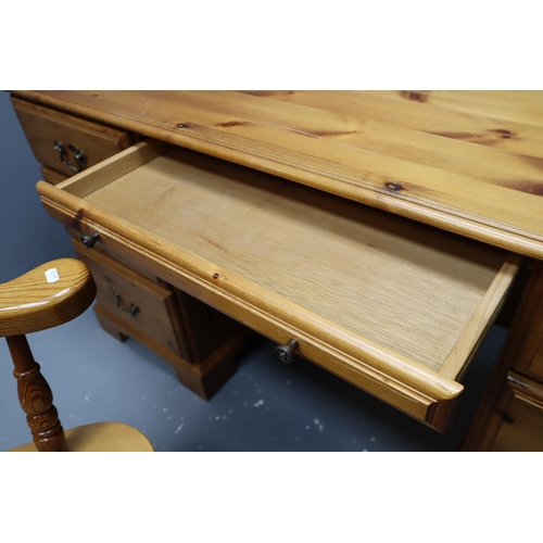 620 - Large pine desk with three large drawers, one small centre drawer and a cupboard with shelf and chai... 