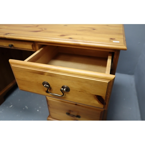 620 - Large pine desk with three large drawers, one small centre drawer and a cupboard with shelf and chai... 