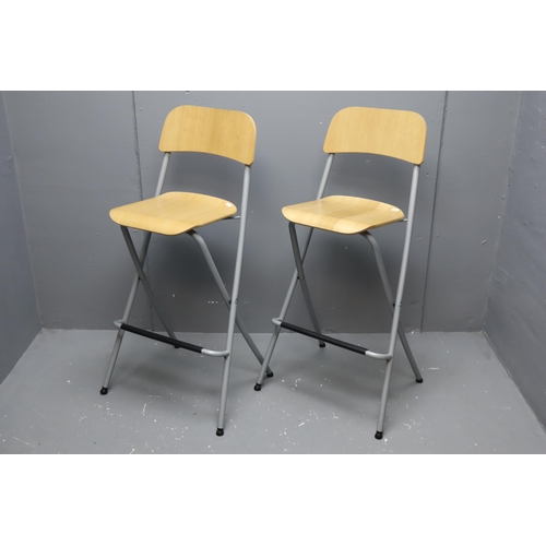 Two IKEA foldable breakfast bar/bar stools with foot rests in beachwood