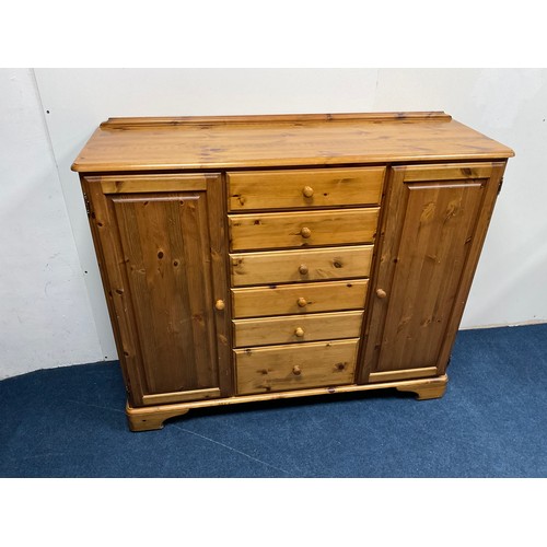 524A - Ducal Pine storage Cabinet with two side cupboards each containing two shelves and six central drawe... 