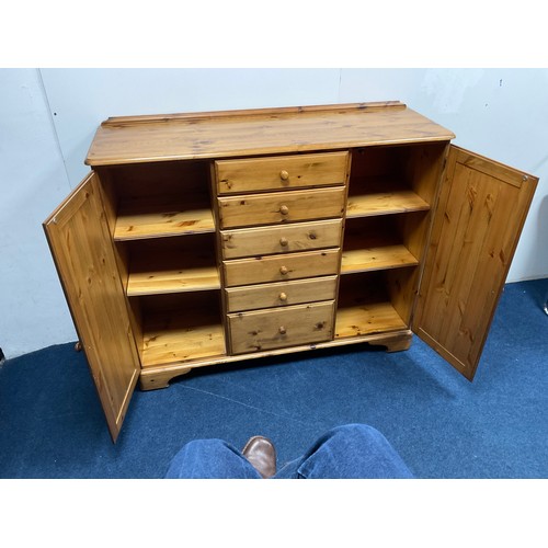 524A - Ducal Pine storage Cabinet with two side cupboards each containing two shelves and six central drawe... 