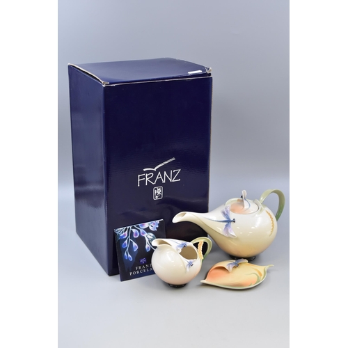 Three pieces of Franz Dragonfly porcelain designed by Jen Woo, teapot, saucer and cream jug. Teapot is boxed.