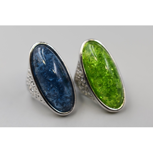 60 - Two 925. Silver Amber Stoned Rings, In Green and Blue