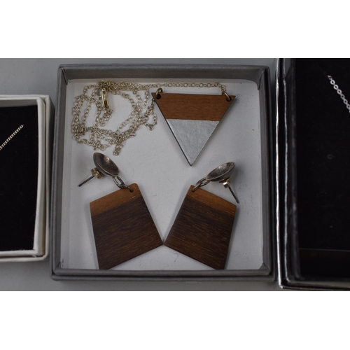 97 - Three Silver 925 Pendant Necklaces and a Silver and Wood Pendant Necklace and Earrings all complete ... 