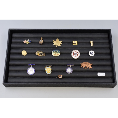Collection of badges and pins of various sizes