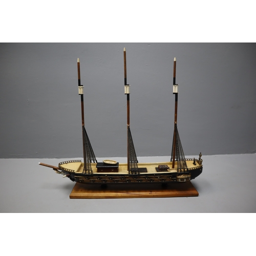 321 - Scale wooden model of a 16th centuary Spanish frigate on a wooden plinth, measures 28