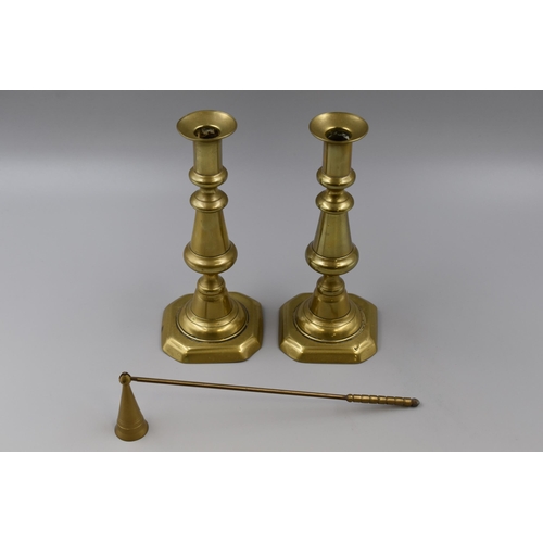 234 - Two brass candle sticks & a snuffer