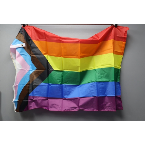 699 - Seven Packs of Gay Pride Decorations. Each Pack Includes Ten Wrist Bands, One Flag, And Ten Flag Sti... 